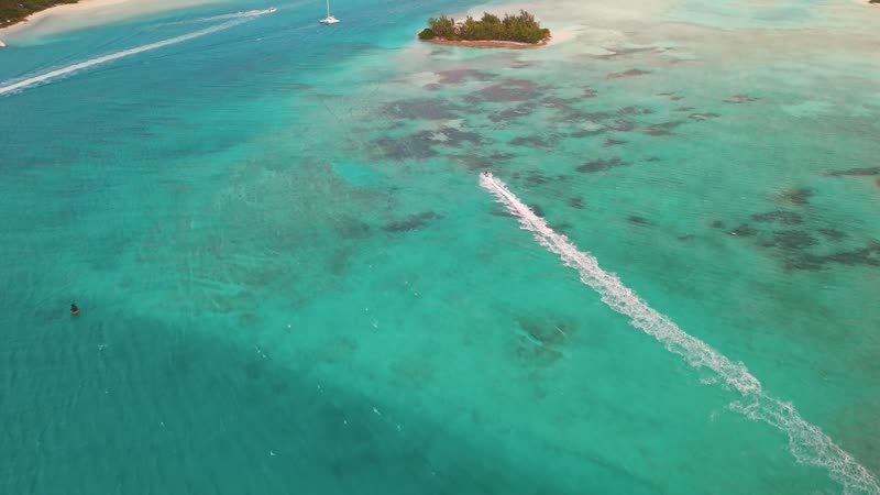 Drone shot following jetski pass by Star Island
