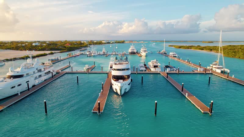 Drone shot focused on a luxury yacht docked at Blue Haven Marina