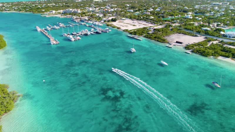 Drone shot of small boat entering Blue Haven Marina