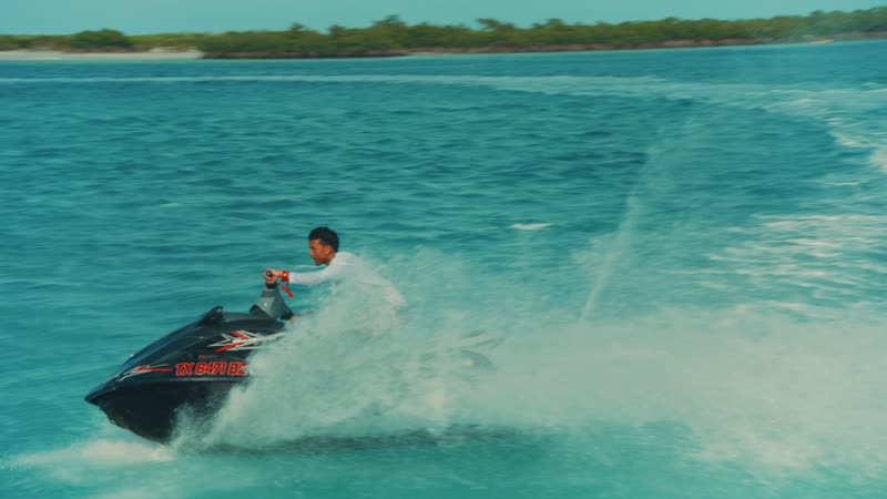 Handheld shot of tourist aggressively riding jetski