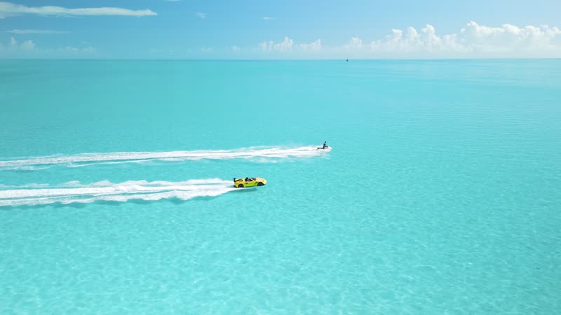 Slow-motion drone shot of jetski and jetcar in bright Long Bay waters