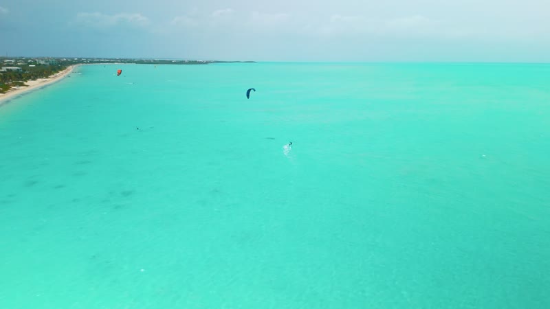Drone shot of kitesurfers in Long Bay