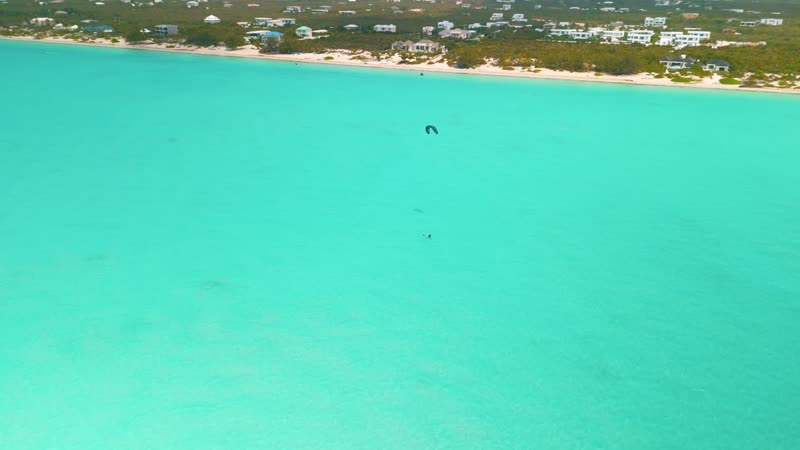 Drone shot of kitesurfers in Long Bay