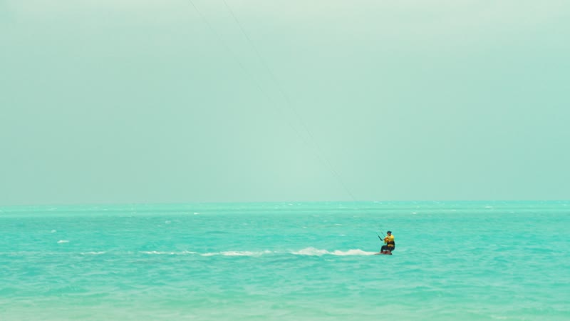 Handheld shot of kitesurfers in Long Bay