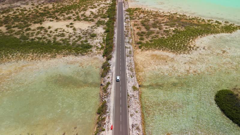 Drone shot following car cross Middle Caicos causeway