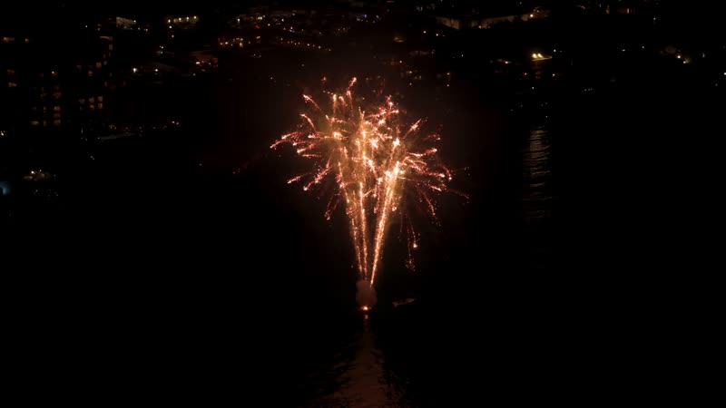 Nighttime drone shot of fireworks over Grace Bay Beach during New Years Eve