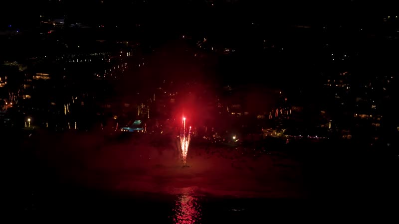Nighttime drone shot of fireworks over Grace Bay Beach during New Years Eve