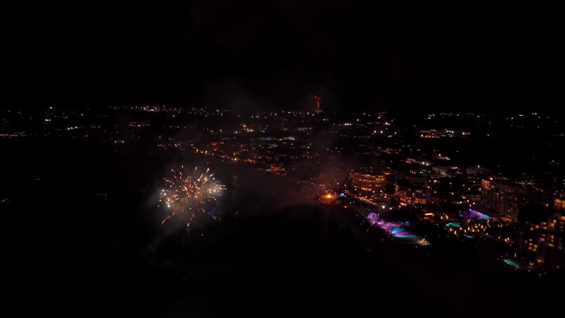 Nighttime drone shot of fireworks over Grace Bay Beach during New Years Eve