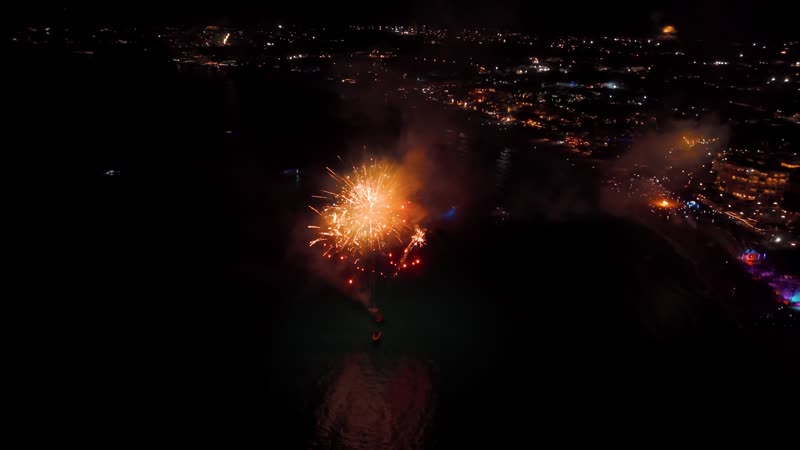 Nighttime drone shot of fireworks over Grace Bay Beach during New Years Eve