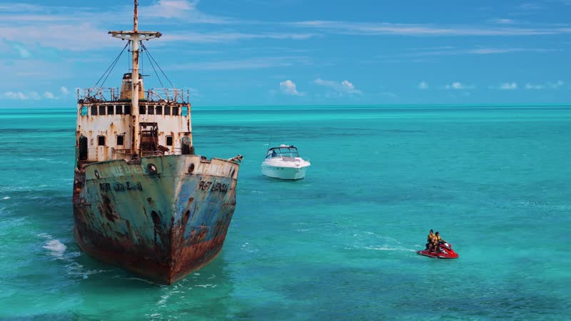 Drone shot panning around yacht and shipwreck